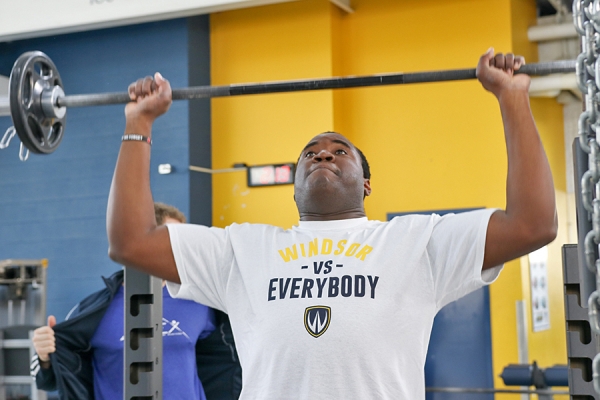 Man lifting weights as part of adaptive exercise program