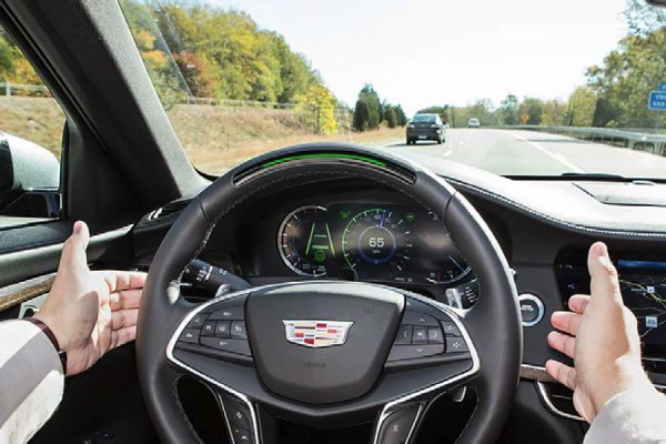 Hands lifting off steering wheel