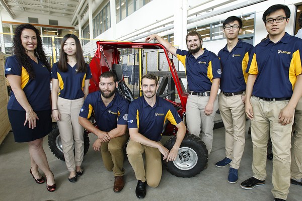 Members of the Lancer Motorsports team pose with their baja car capstone project.