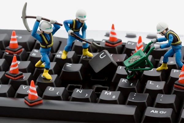 toy workers digging up keyboard