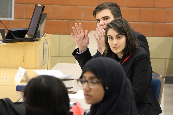 Students from Assumption and Massey high schools face off in debate Friday at the Odette School of Business.
