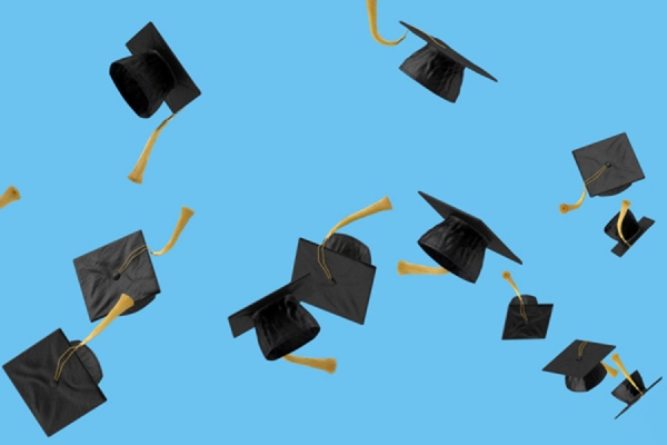 graduation caps flying through blue sky