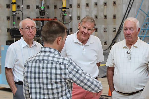 Second-year civil engineering student Jason Duic speaks with alumni David Strelchuk, Philip Waier, and Henry Regts.