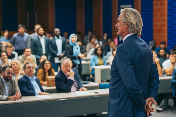 Michael McCain addressing full lecture hall