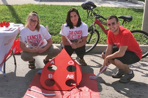 Members of the UWindsor Blood Club offer a game and book donation appointments during Open Streets 2017.