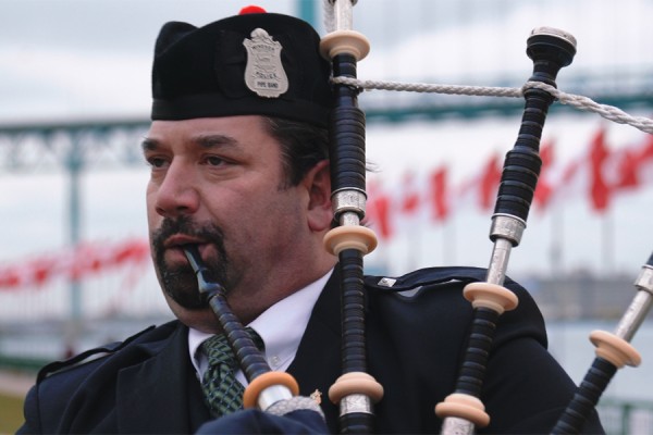Ryan Burchiel of the Windsor Police Pipe Band plays a role in the campus ceremony marking Remembrance Day.