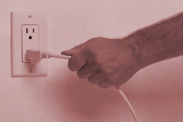 hand pulling plug from outlet