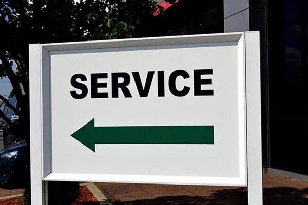 Sign with arrow pointing in direction labelled &quot;Service&quot;
