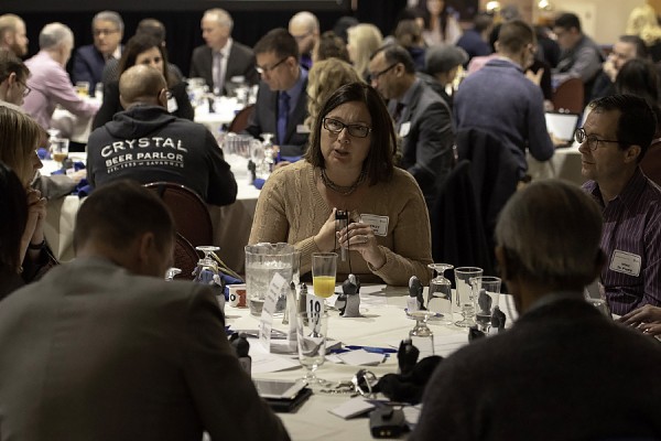 People sitting at tables consulting