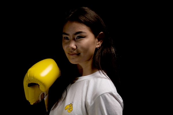 student wearing boxing gloves, poised to punch a virus