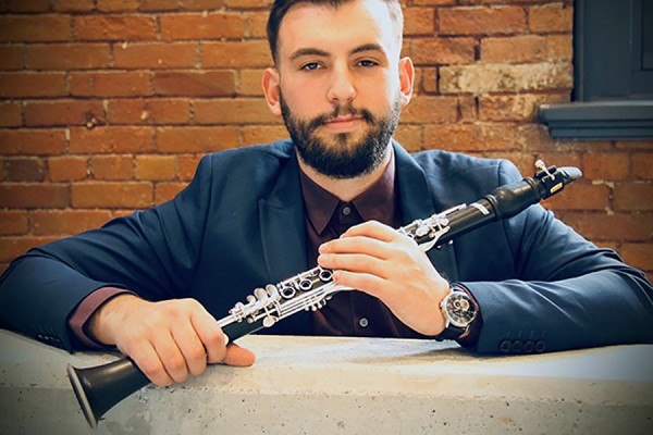 Tomi Xhelili holding clarinet