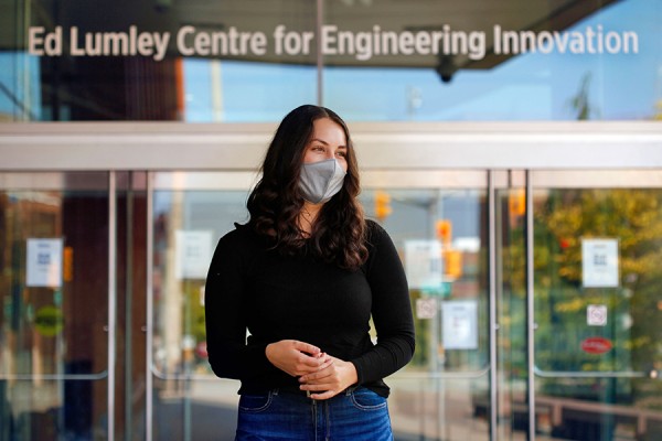 woman standing outside entrance to Centre for Engineering Innovation