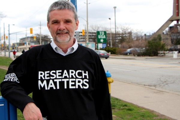 Bill Anderson wearing &quot;Research Matters&quot; shirt.