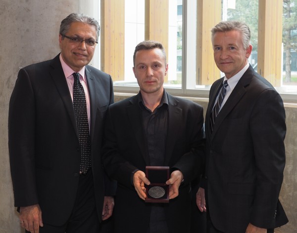 Dean Mehrdad Saif (l.) and Provost Douglas Kneale (r.) presented engineering professor Vesselin Stoilov (m.) with a medal, honouring him at the newly-established awards program that recognizes the contributions of faculty and staff. 