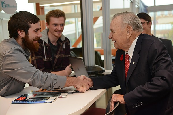 Ron Joyce (right) meets some students