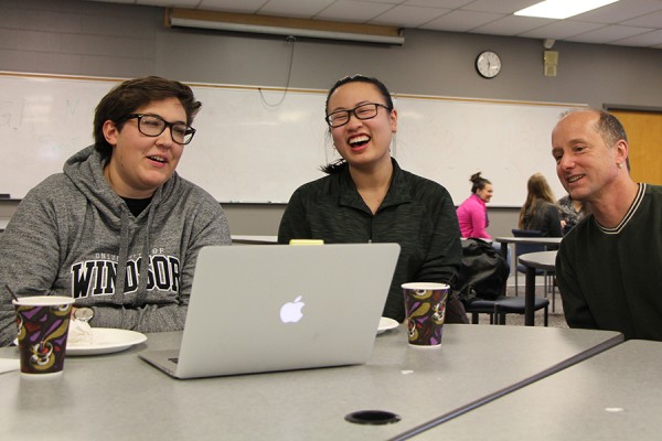 Students Gisele Gagnon and Donna Liu share a laugh with department head Dennis Higgs