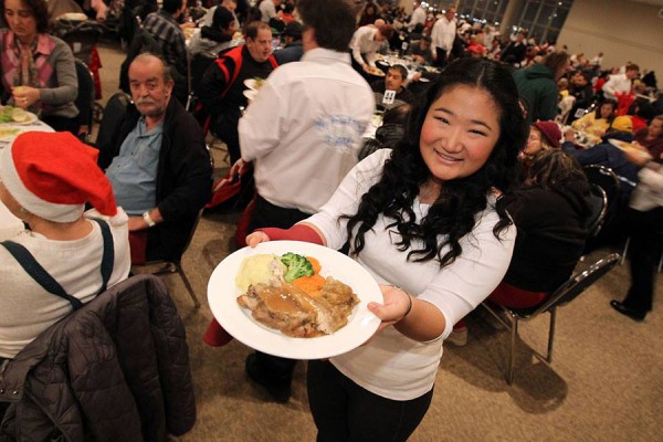 UWindsor student Eileen Chen serves a holiday meal at a dinner for Windsor’s needy.