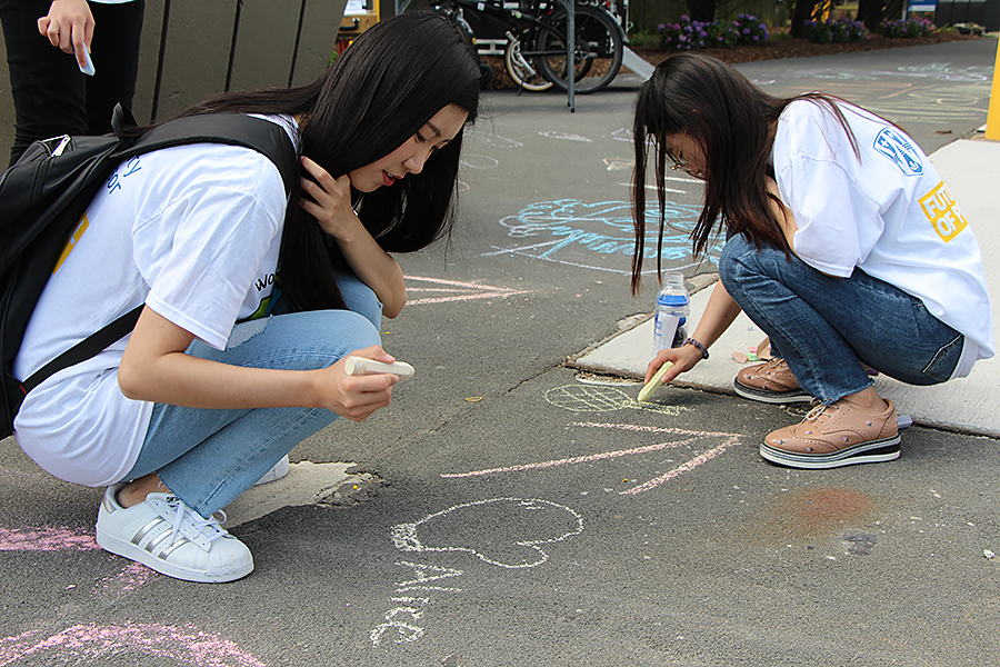 students chalking sidewalk