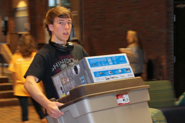 kid hauling boxes to dorm room