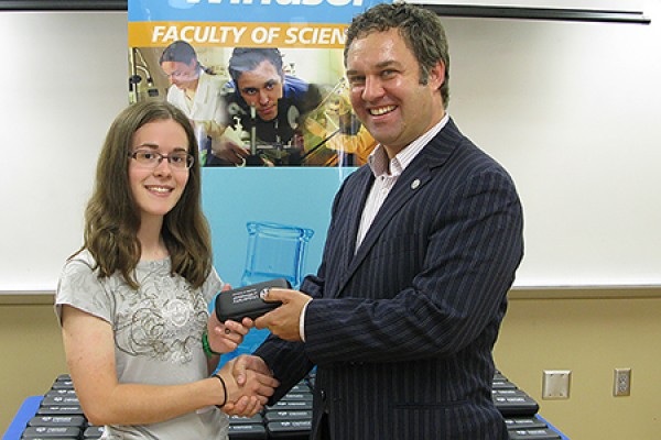 Brittany Ives shaking hands with Charles Macdonald