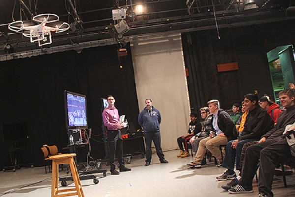 Jon Sinasac of the Centre for Teaching and Learning demonstrates a drone-mounted camera before an audience of high school students.