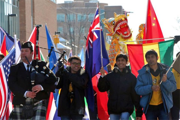 students carrying flags of many countries