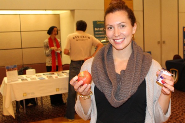 woman holding apple and yogurt