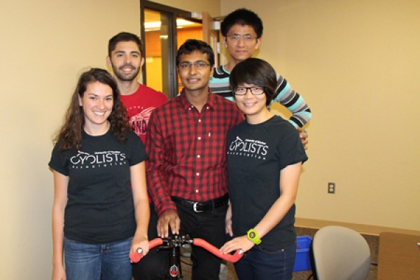 students stand around bike