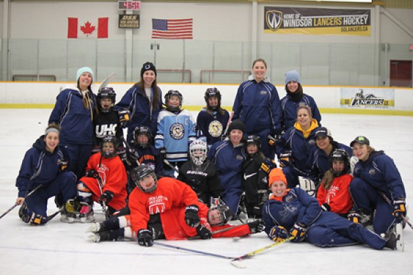 Members of the Lancer women’s hockey team pose with Kent Fillies.