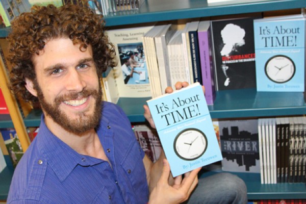 Justin Teeuwen holding copy of &quot;It&#039;s about TIME&quot;