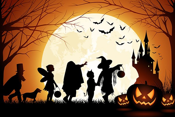 full moon rising behind children in costume