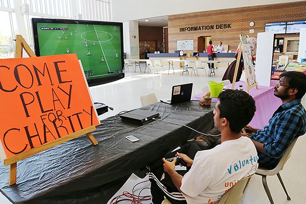 young men playing video games for charity
