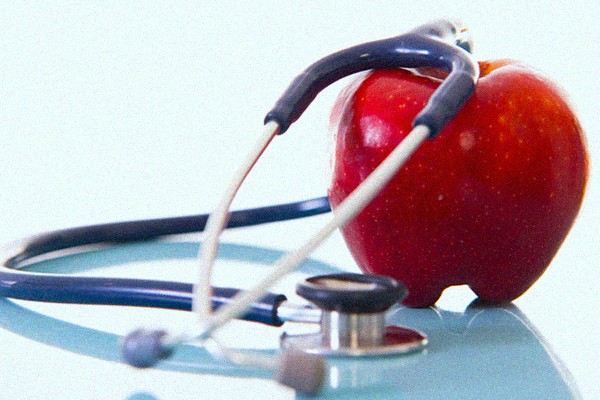 apple wrapped in stethoscope