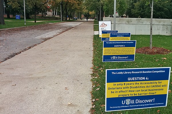 Colourful signs around the campus pose the contending questions to passersby.