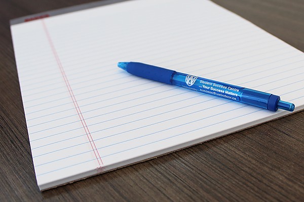 Pen and pad of paper