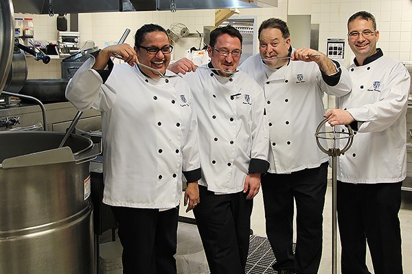 Roshelle Mathias, Peter Polak, Brian Joyce and Andrew Braithwaite mimic sampling soup from large ladles