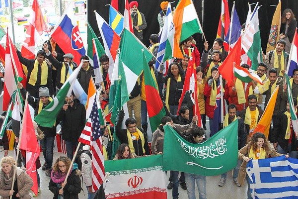 students holding flags of many nations