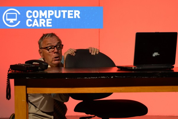 Man cowering before computer
