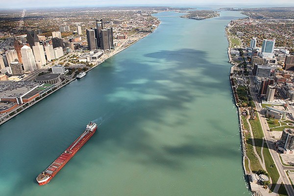 aerial photo of Detroit River showing cities on both banks
