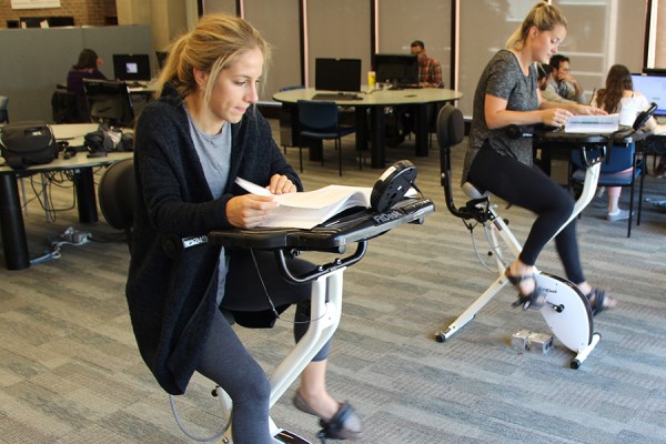 Sara Santarossa and Paige Coyne pdealling exercise desks