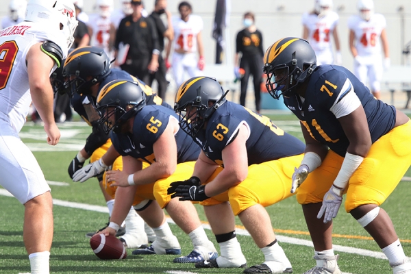Lancer football players on scrimmage line
