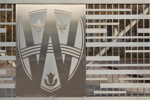 closed gate across entrance to campus