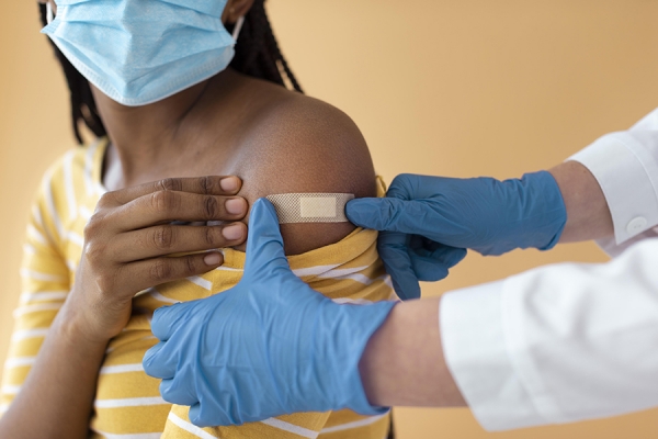 vaccine being administered in upper arm
