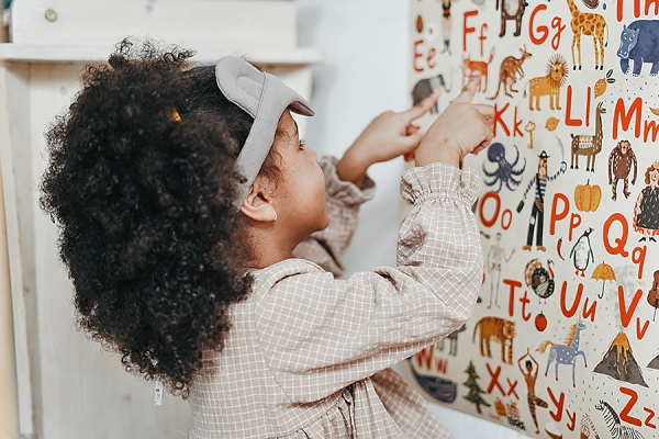 child working with alphabet