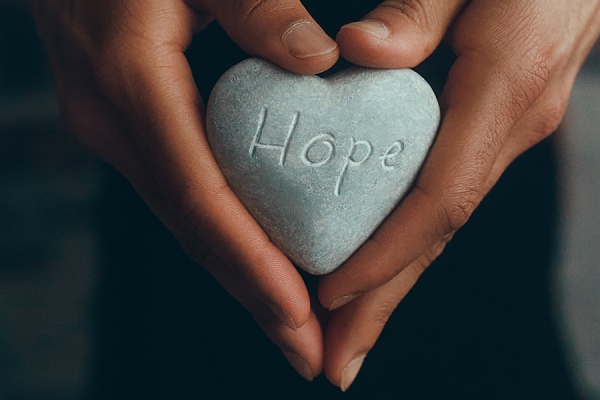 heart-shaped rock with word &quot;hope&quot; carved into it