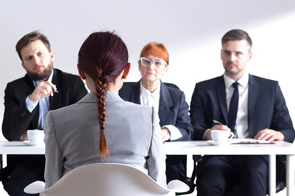 woman facing interview panel