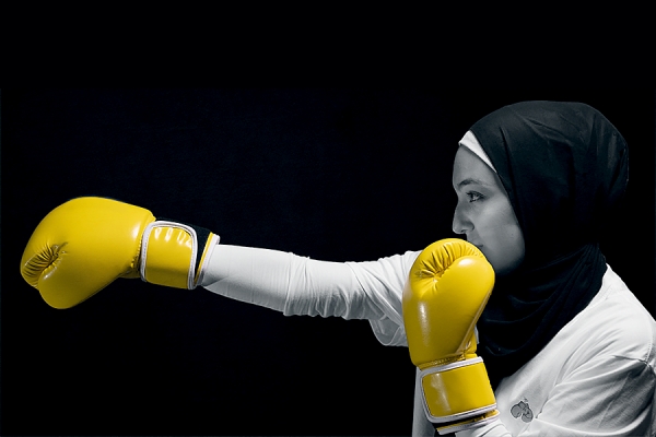 woman in hijab taking jab against COVID