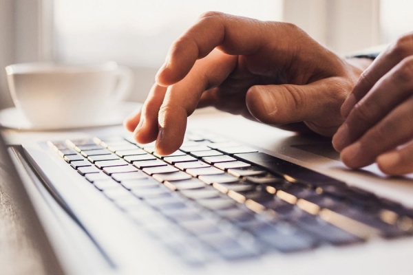 hands over computer keyboard