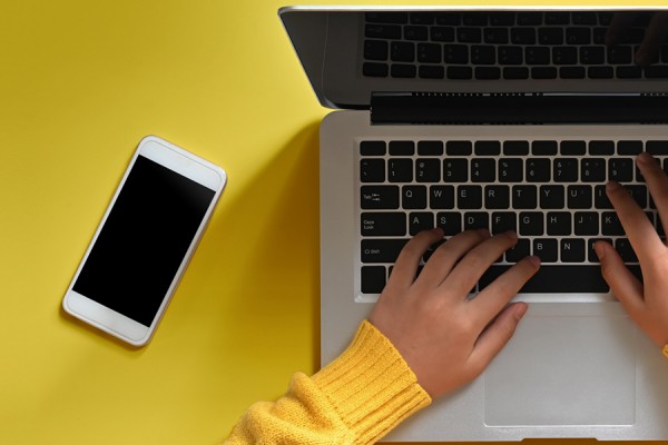 hands on laptop keyboard