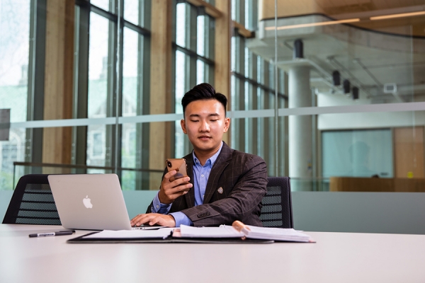 student on computer and smartphone